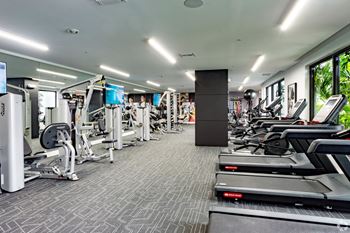 Our state-of-the-art fitness center with treadmills, free weights, and exercise machines at Hollywood Heights on the Boulevard Luxury Apartments in Hollywood, FL